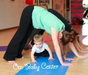 A woman and two children are doing yoga.